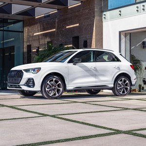 Side view of an Audi Q3 driving.